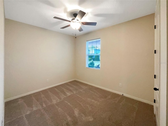 unfurnished room with dark carpet and ceiling fan