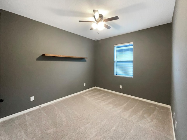 spare room featuring carpet flooring and ceiling fan