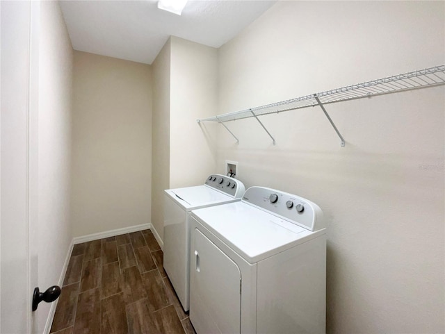 laundry room featuring washing machine and clothes dryer and dark hardwood / wood-style floors