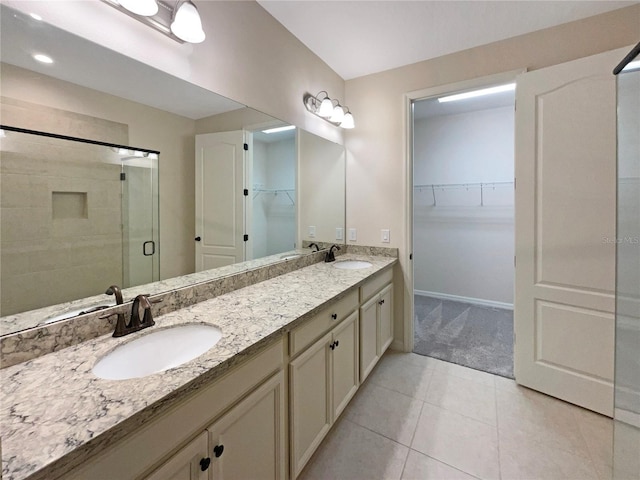 bathroom with tile patterned flooring, vanity, and an enclosed shower