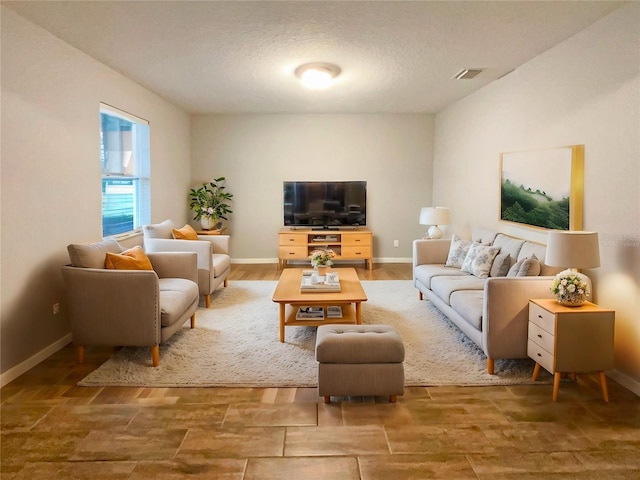 living room with hardwood / wood-style floors and a textured ceiling