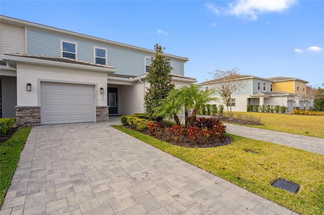 view of front facade with a front yard and a garage