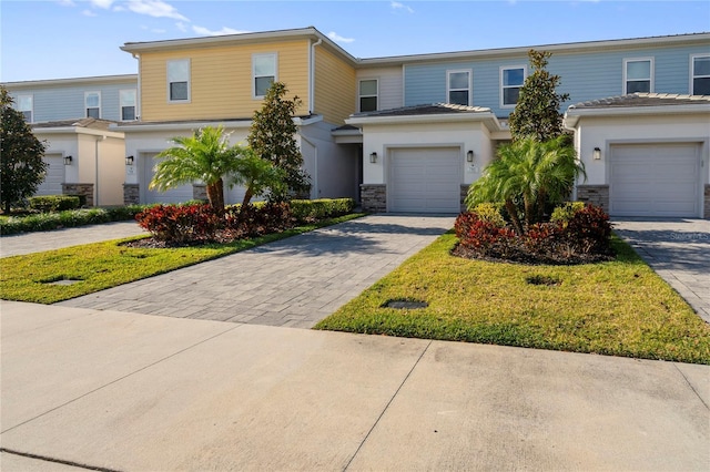 view of front of house with a front yard and a garage