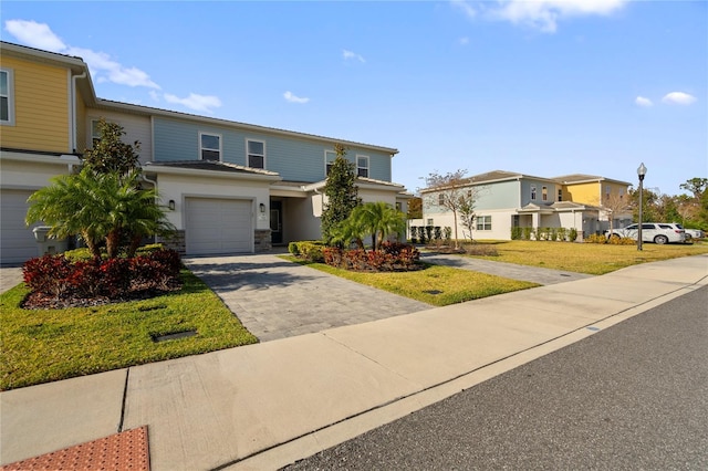 front facade featuring a garage and a front lawn