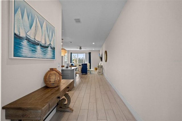 corridor featuring light hardwood / wood-style floors