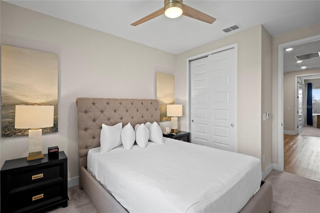 bedroom with light hardwood / wood-style floors, a closet, and ceiling fan