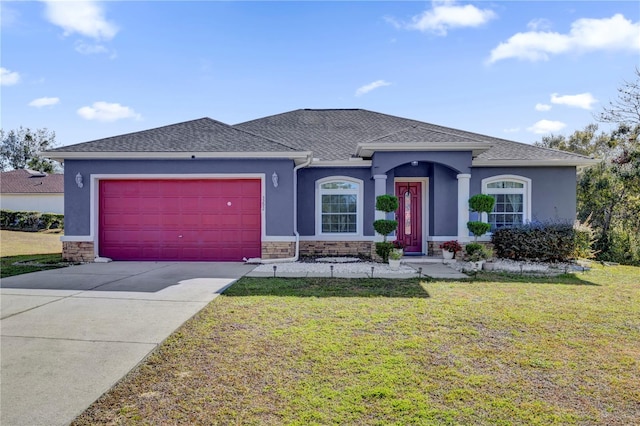 view of front of home with a front yard and a garage