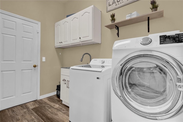 laundry area featuring dark hardwood / wood-style floors, cabinets, and separate washer and dryer