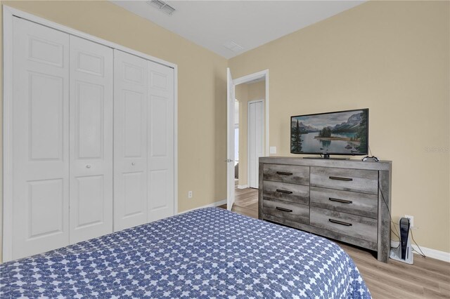 bedroom featuring a closet and light hardwood / wood-style flooring