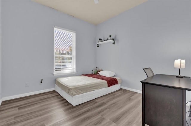 bedroom with wood-type flooring