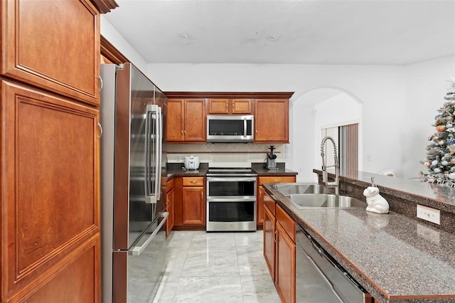 kitchen featuring decorative backsplash, sink, and appliances with stainless steel finishes