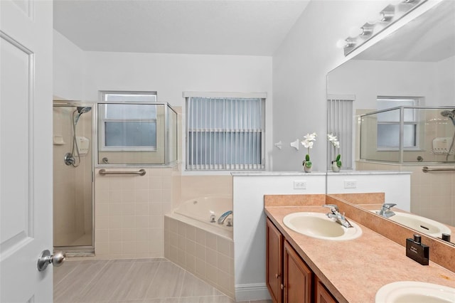 bathroom with tile patterned flooring, shower with separate bathtub, and vanity