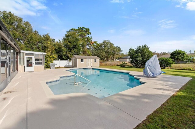 view of pool featuring a shed and a patio