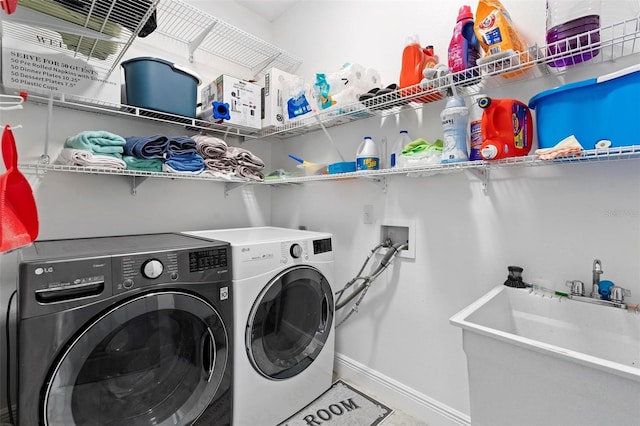 washroom featuring independent washer and dryer and sink