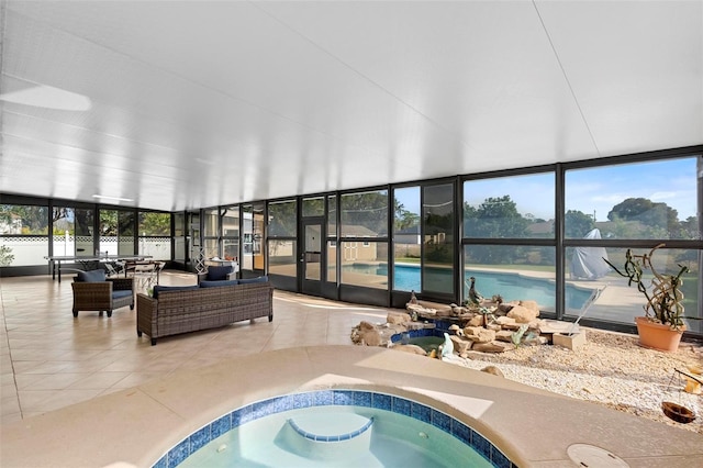 sunroom with plenty of natural light and a pool with hot tub