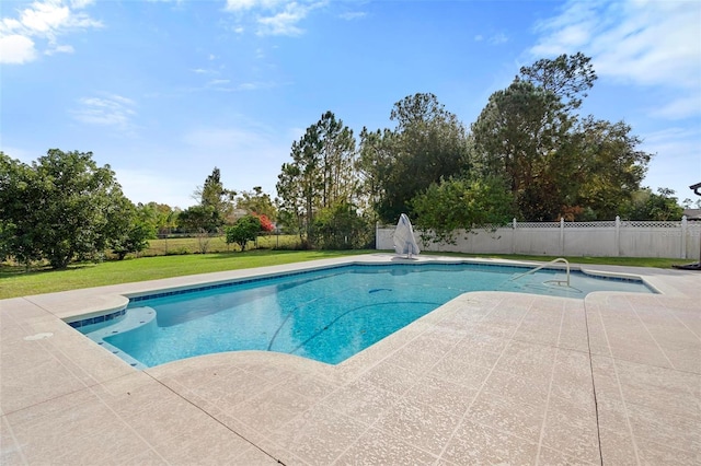 view of pool with a patio area and a yard