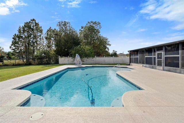 view of swimming pool featuring a patio area, a sunroom, and a yard