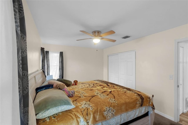 bedroom featuring ceiling fan, a closet, and wood-type flooring