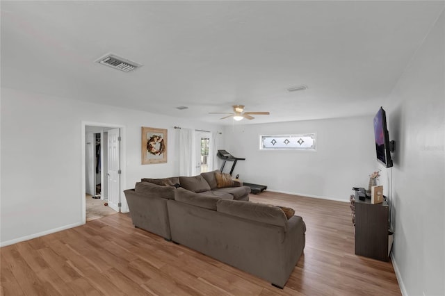 living room featuring light hardwood / wood-style floors and ceiling fan