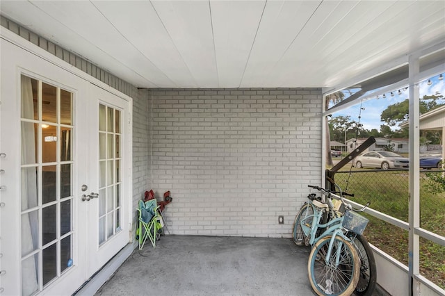 unfurnished sunroom featuring french doors