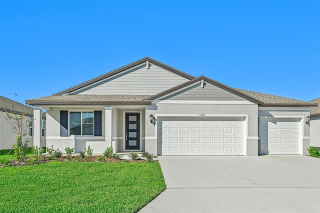 ranch-style home featuring a garage and a front lawn