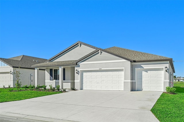 ranch-style house featuring a front yard and a garage