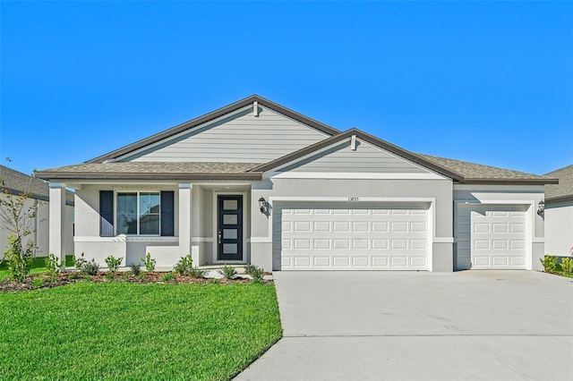 single story home featuring a front lawn and a garage