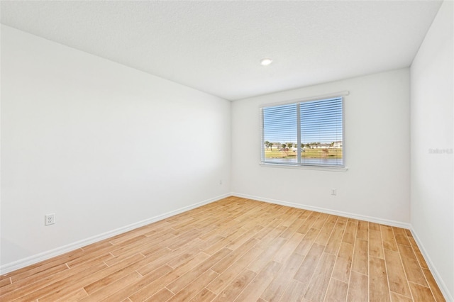 unfurnished room featuring light hardwood / wood-style flooring