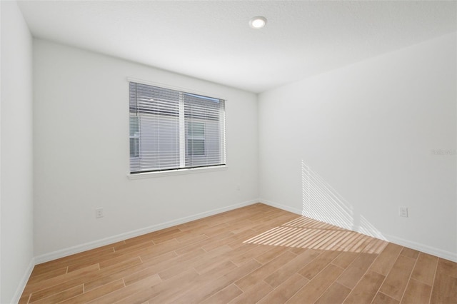 spare room with light wood-type flooring