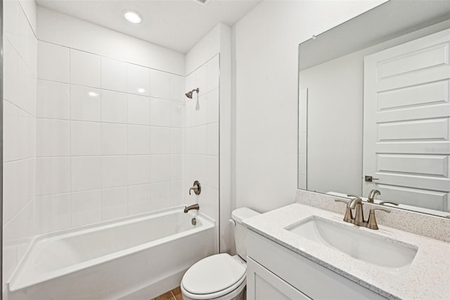 full bathroom with toilet, tiled shower / bath combo, and vanity