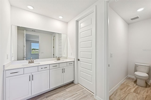 bathroom featuring toilet and vanity