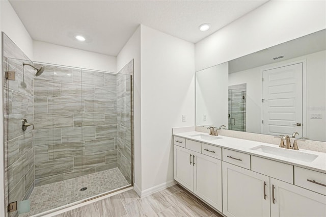 bathroom featuring vanity and a shower with shower door