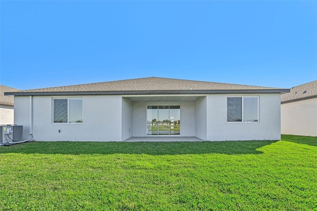 back of property featuring a patio, central air condition unit, and a yard