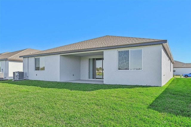 back of property with cooling unit, a patio, and a yard