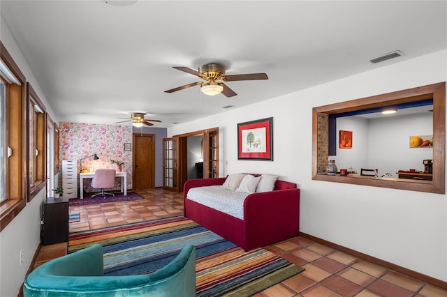 living room featuring tile patterned floors, ceiling fan, and french doors