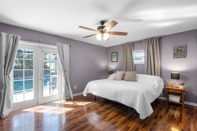 bedroom with access to exterior, ceiling fan, dark wood-type flooring, and multiple windows