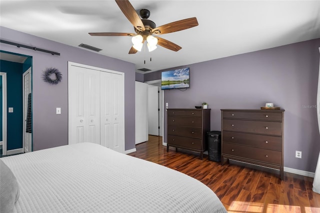 bedroom featuring ceiling fan, dark hardwood / wood-style flooring, and a closet