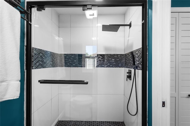 bathroom featuring a shower with door