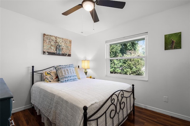 bedroom featuring ceiling fan and dark hardwood / wood-style floors