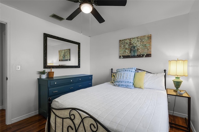 bedroom with dark hardwood / wood-style flooring and ceiling fan