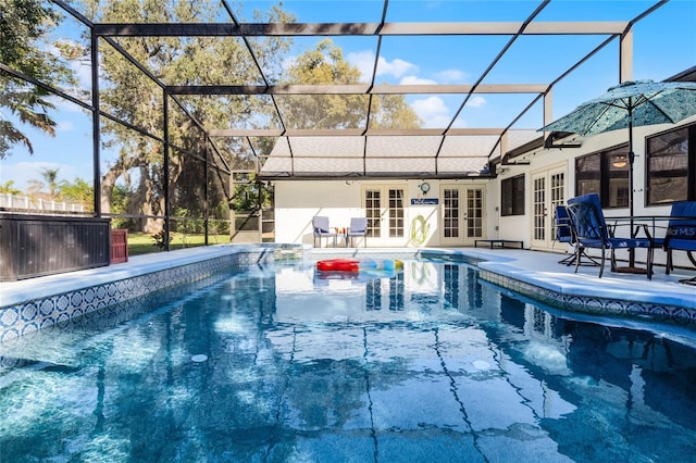 view of swimming pool featuring french doors, a patio, and glass enclosure