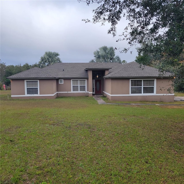 single story home featuring a front yard