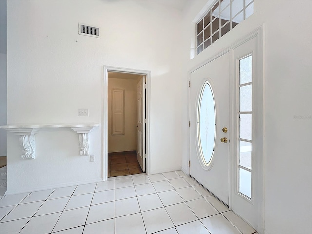 foyer entrance featuring a high ceiling and light tile patterned floors