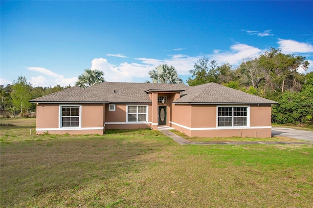 ranch-style home with a front lawn