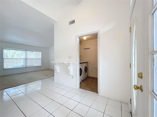 interior space featuring light tile patterned flooring and independent washer and dryer