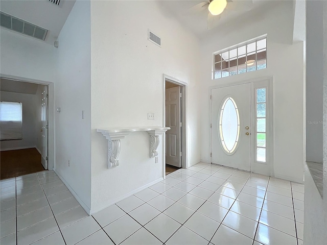 foyer entrance with a high ceiling and light tile patterned floors