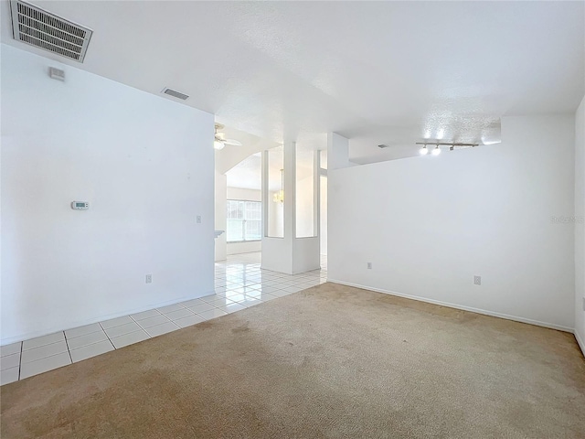 carpeted spare room featuring ceiling fan