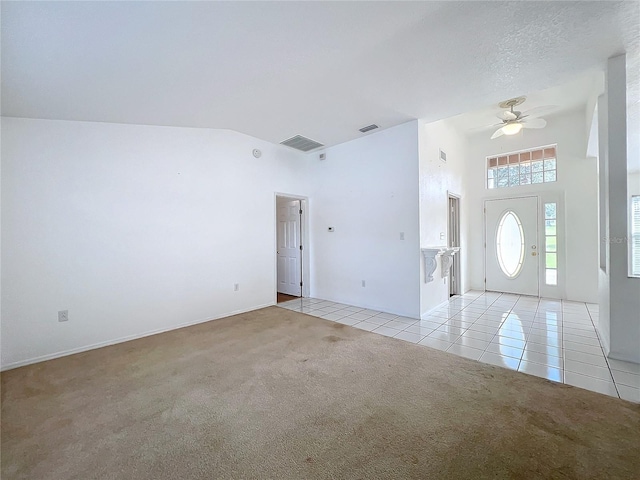 spare room with light carpet, ceiling fan, high vaulted ceiling, and a textured ceiling