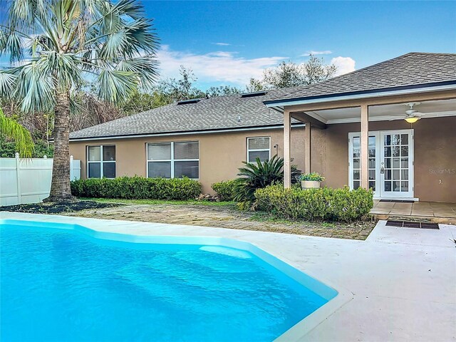 view of swimming pool featuring a patio, french doors, and ceiling fan