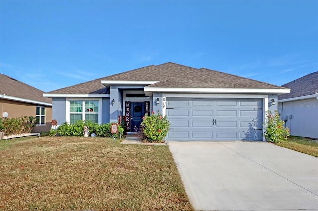 view of front of property with a garage and a front yard